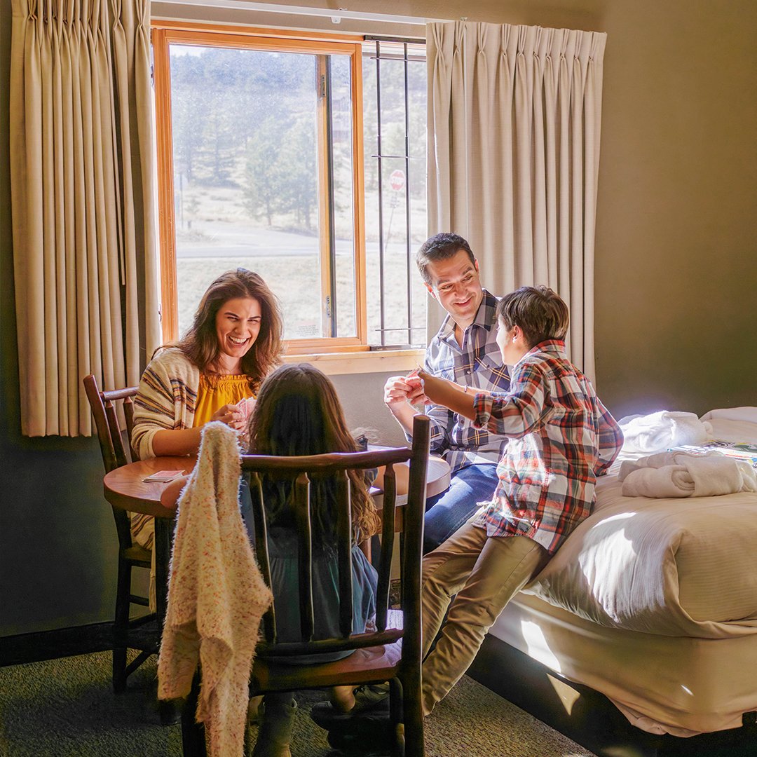 Family of 4 playing cards in a lodge room.